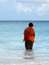 Meditation in blue and orange. Lady looking at the horizon. Sea and sky. Beach Dreams.