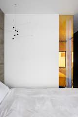 the bedroom & a view to the shower through a corner dichroic glass