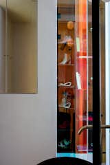a view through the corner dichroic glass to the bedroom's United Nude shoes closet 