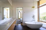The master bathroom is flooded with light and views while maintaining privacy screened by the scrub oak preserved on lot.