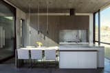 Kitchen and dining are combined to keep the main house's footprint compact and functional.  Floating cabinets provide separation and privacy for the guest room.