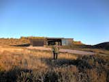 Nestling into the hillside next to a stand a aspen trees gives the home a cozy, protected feeling in the exposed hills of Idaho.