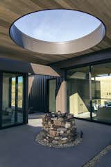 The oculus over an ever-growing stone cairn marks the time of day and the change of seasons as the light traces the suns path through each living space.  Visitors are invited to add a stone to the cairn with each visit they make.