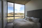 Wall to wall, floor to ceiling glass blurs the boundary between the master bedroom and the rolling hills of southern Idaho.