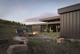 Exterior, Metal Siding Material, Cabin Building Type, House Building Type, Flat RoofLine, and Small Home Building Type The central court with outdoor fire pit views a stand of quaking aspen trees where the nearest neighbor [a moose] resides.  Photo 4 of 18 in The Boar Shoat by Imbue Design