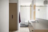 A play of light and shadow give the master bathroom a dramatic, but light mood.