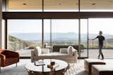 Lift-and-slide doors slide away into the wall to create a seamless connection to the rooftop patio beyond.