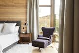 Rich tactile materials along with nature flowing in through corner windows gives the master bedroom a cozy, relaxing atmosphere.
