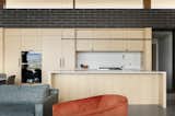 White oak acts as a visual and tactile counterpoint to dark brick throughout the home.
