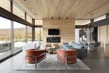 An open living plan creates a light airy space that is connected to nature on all sides through large ribbons of glass.