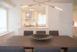 OPEN DINING ROOM - CONTEMPORARY NYC RENOVATION: In contemporary lifestyle trends, the kitchen is the heart of the home. By maximizing on lighting and layout we create a uninterrupted flow between kitchen and living areas for great entertaining and easy every day living. The open pass through with Italian glass pendant lighting is a favorite!