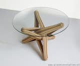 "LOCK" coffee table is designed out of the qualities, possibilities and characteristics of its highly sustainable material: BAMBOO. The frame is build up from layers of flexible bamboo. The layers are pressed together. The shape is formed by the bamboo's natural bending curve. The layers of bamboo curve through each other and entwine, locking each other in place.