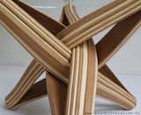 "LOCK" coffee table is designed out of the qualities, possibilities and characteristics of its highly sustainable material: BAMBOO. The frame is build up from layers of flexible bamboo. The layers are pressed together. The shape is formed by the bamboo's natural bending curve. The layers of bamboo curve through each other and entwine, locking each other in place.