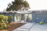 The front entry opens onto a courtyard revealing a central glass atrium