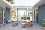 Per the client wishes to keep the home true to its conceptual roots, Gast Architects preserved the H-shape footprint and expanded the atrium space connecting the public and private wings