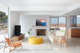 A creamy terrazzo floor with a zoned radiant heat system was poured and polished throughout the home as seen here in the living room and adjacent kitchen