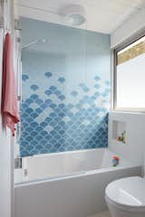 A whimsical jack & jill bathroom connects two of the bedrooms
