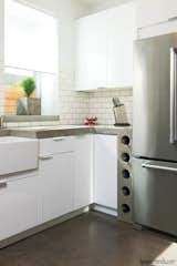 Kitchen, Concrete Counter, White Cabinet, Refrigerator, and Concrete Floor  Photo 2 of 11 in Johnson-Leeds Residence by GreyWall Development & Design 