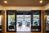 Knowing that the family will gather at the home mostly on the weekends where the number of visitors could also increase, the plan utilized a large screened porch and deck that allows the main living space to expand and open onto these spaces through a series of 8’ high sliding glass doors.  