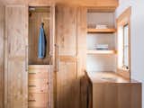 Blond wood shaker style closet in guest bedroom