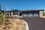 Front entry and driveway with natural landscape