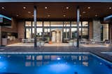 Covered rear patio with dining, cooking and seating areas