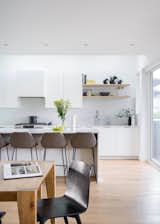An auxiliary dwelling in the rear yard was designed to be a ground oriented one store dwelling for aging parents keeping future adaptability in mind. The spaces are lofty and bright with ample custom cabinetry to optimize storage and utility in the compact dwelling. With a baby grand at the heart of this space, the client's mother has nicknames the building her "jewel-box", claiming that her home is perfect for all her treasured things.