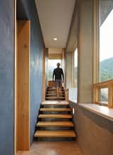 Staircase and Wood Tread Passive Solar Hallway leading to Bedrooms.  Photo 11 of 12 in Strawbale Getaway by Gettliffe Architecture
