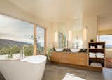 Bath Room, Freestanding Tub, Vessel Sink, Soaking Tub, Concrete Floor, and Wall Lighting  Photo 7 of 10 in Northern Slope Sanctuary by Gettliffe Architecture