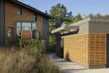 New glazed entrance rotated from existing beach house with new cedar-clad facade