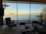 living room w/ deck & view beyond at sunset