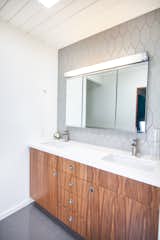 Eichler in Concord, CA - bathroom featuring Fire Clay Tile, floating Walnut vanity, original vintage light bar and mirrors.  Photo 1 of 6 in Mid Century Modern Bathrooms by John Shum