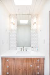 Eichler in Concord, CA - bathroom featuring Heritage 3D hex tile, floating Walnut vanity, original vintage light bar and mirrors.  Photo 2 of 6 in Mid Century Modern Bathrooms by John Shum