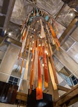 Salvaged crew oars with original boat, numbers and colors are arranged around a black, spiral, steel frame as crystals draped on a delicate chandelier.

This monolithic sculpture is nineteen feet tall and weighs in at just under a ton.

  Photo 4 of 10 in Boatyard Restaurant by Callin Fortis