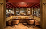 The open kitchen and dining room are divided by gilded ship helm 3D acrylic panels which separate the main dining from the private dining room.