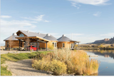 The home has its private own lake and prime views of Colorado's National Monument, so naturally the focus for family and friends is to get outdoors. The sprawling site has a number of camping pads, parking areas,  fire pits, and three outdoor showers, not to mention a putting green.  Photo 1 of 9 in A Yurt-Inspired Vacation Home on the High Desert Plains of Colorado