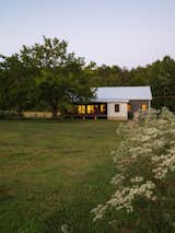 Exterior, Shed RoofLine, Concrete Siding Material, Metal Roof Material, Gable RoofLine, House Building Type, Farmhouse Building Type, Metal Siding Material, and Small Home Building Type Exterior in context  Photo 11 of 13 in Raccoon Crossing by Terry Wyllie