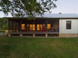 Exterior, Shed RoofLine, Gable RoofLine, Farmhouse Building Type, Small Home Building Type, Metal Siding Material, House Building Type, Concrete Siding Material, and Metal Roof Material Exterior Screen Porch & Siding  Photo 9 of 13 in Raccoon Crossing by Terry Wyllie