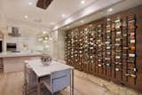 This wine room features a cork floor and natural wood backing, with Wall Series metal wine racks in Satin Black finish holding bottles in contemporary style.   VintageView Wine Storage Systems’s Saves from Wall Series Metal Wine Racks