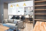 Office, Shelves, Desk, Light Hardwood Floor, Chair, and Study Room Type  Photo 10 of 18 in Startup office in Prezlauer Berg by Maxim Kurennoy