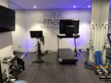 A fitness room in the basement provides a peloton bike and tread for home workouts 