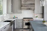 Zinc island top, Caesarstone perimeter countertops, hood wrapped in barnwood
