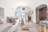 Carved into the majestic Caldera cliffs of Santorini's most famous village, Oia, this yposkafo was renovated in 2016 and comes with an indoor and outdoor jacuzzi and an inviting interior finished with soft grays and pale blues.