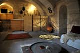 Bath Room, Limestone Floor, and Wall Lighting The three suites of Asmali Cave House in Cappadocia come with living rooms and kitchens, spacious bedrooms and unusual bathrooms.  Photo 10 of 11 in 10 Incredible Cave Hotels and Vacation Rentals