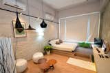 With a double bed on a raised wooden platform, white washed brick walls and Tom Dixon pendant lights, this small 313 square feet studio apartment is perfect for single travellers or couples.