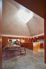 Dining Room, Concrete Floor, Table, Chair, and Pendant Lighting  Search “interview-with-jurgen-mayer-h-part-i.html” from Red Tin House That Makes the Most of Space and Light