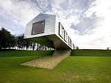 Designed by Rotterdam-based practice MVRDV and British firm Mole Architects, the cantilevered Balancing Barn in Suffolk is almost 100 feet long, with half of its body jutting forward from a slope and straight out into the open space.