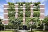 Designed by sustainable Vietnamese practice Vo Trong Nghia, the Atlas Hotel in Hội An, Vietnam, has more that 100 cantilevered concrete planters. The trailing plants that overhang from the balconies create the effect of a green facade that shades the guest rooms from the strong sunshine.&nbsp;