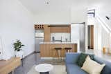 Kitchen, Wood Cabinet, Concrete Floor, Refrigerator, Ceramic Tile Backsplashe, Range, and Undermount Sink  Photo 1 of 10 in Small Apts by Lisa Leeming from What Looks Like a Single Dwelling in Melbourne Actually Holds Six Walk-Up Apartments