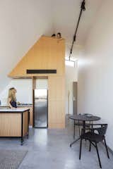 Kitchen, Wood Cabinet, Concrete Floor, Refrigerator, Ceiling Lighting, and Cooktops  Photo 14 of 14 in What Looks Like a Single Dwelling in Melbourne Actually Holds Six Walk-Up Apartments